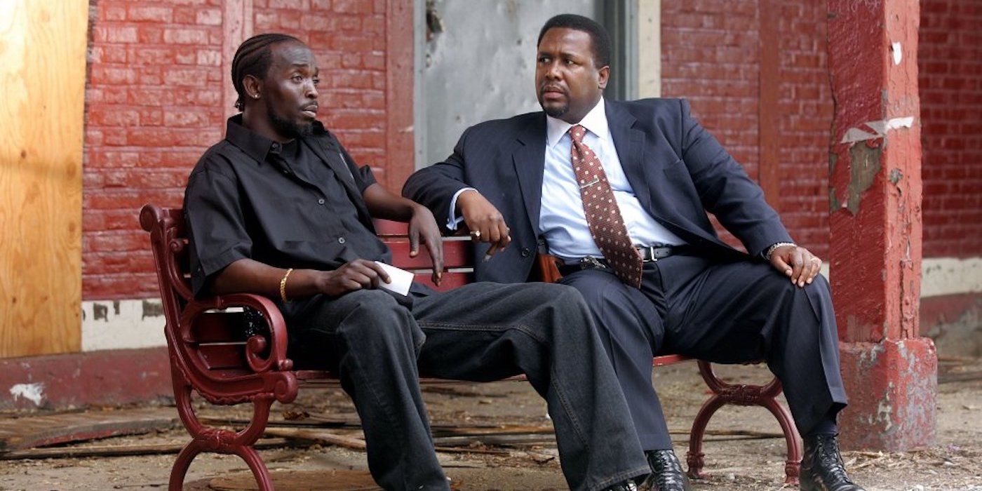 Michael K. Williams as Omar Little and Wendell Pierce as Banka sit on a bench at The Wire