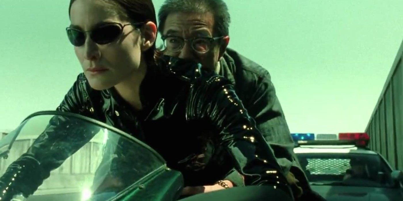 Carrie-Anne Moss as Trinity rides a motorcycle in The Matrix Reloaded. 