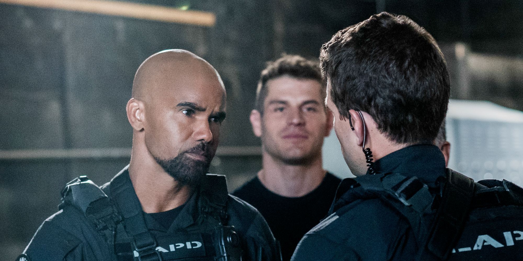 Three people in the form of special forces are talking