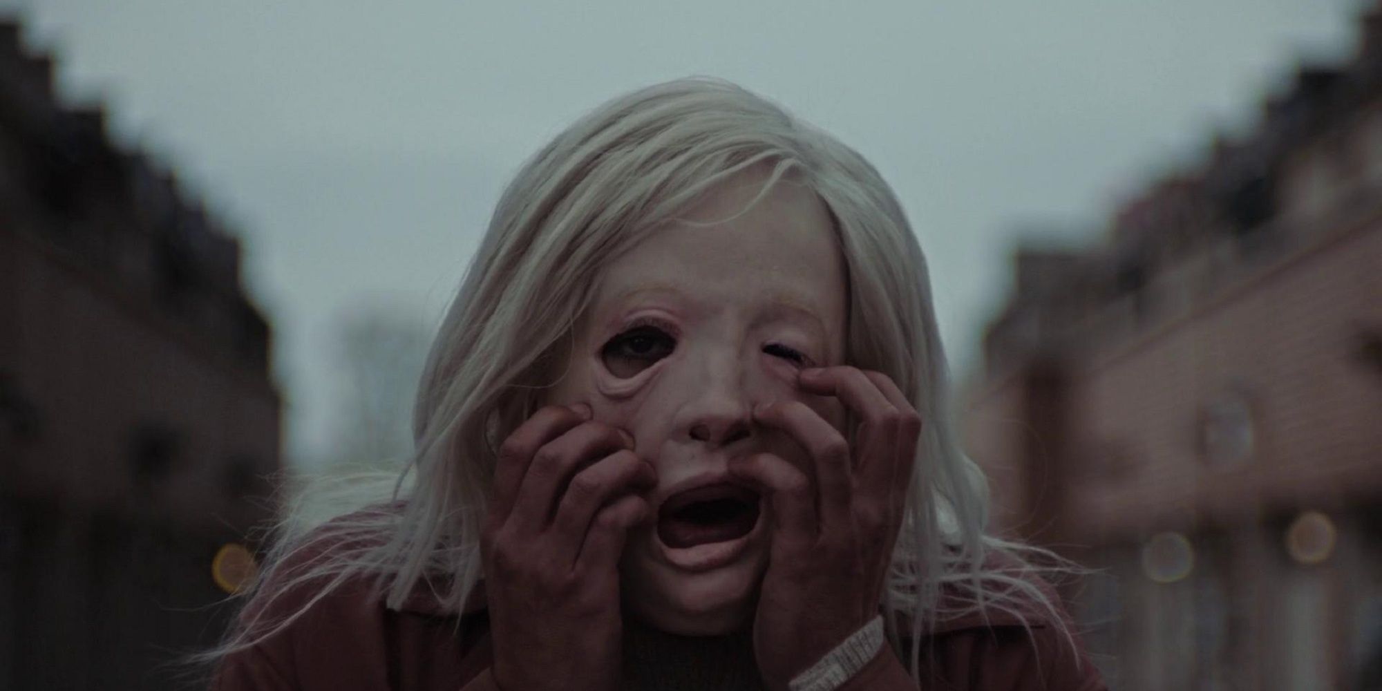 The woman trying to rip off her mask in the movie The Lord.