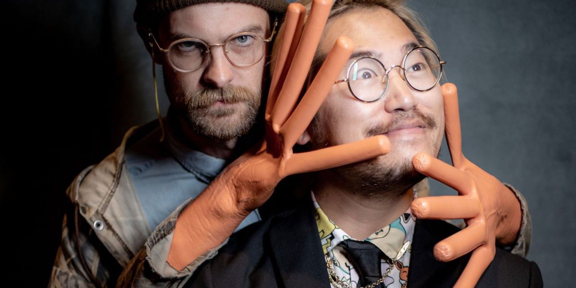 Daniels poses for a photograph with large hands that look like a hot dog.
