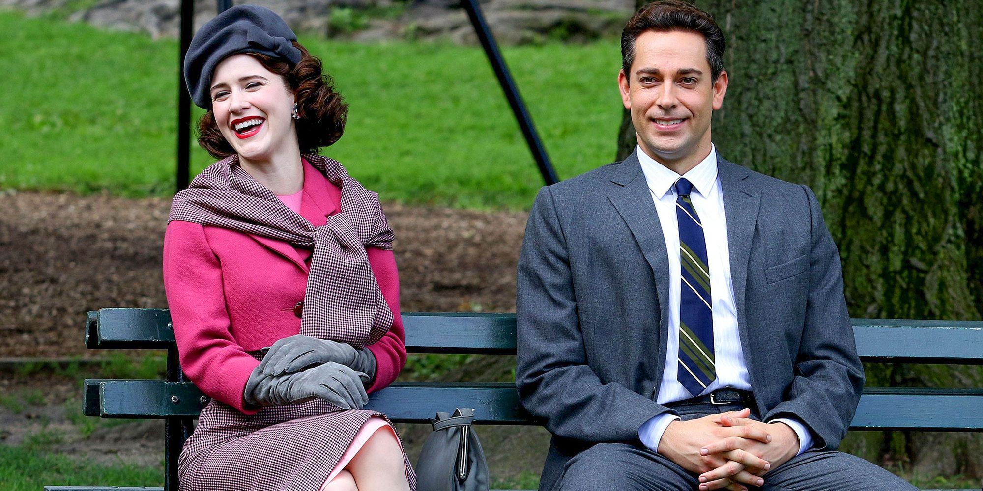 Midge and Joel from The Marvelous Mrs. Maisel sit together on a park bench.