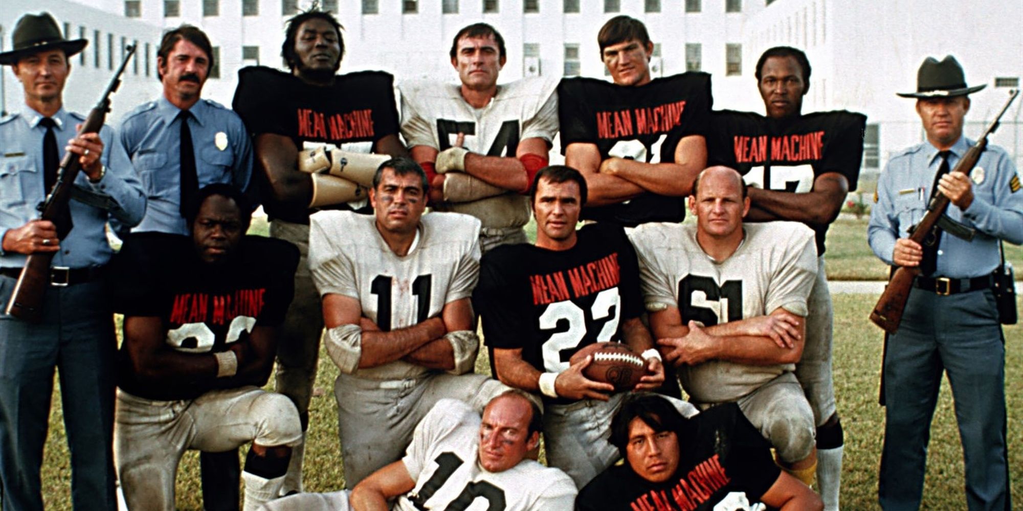 Group of soccer players posing between prison guards