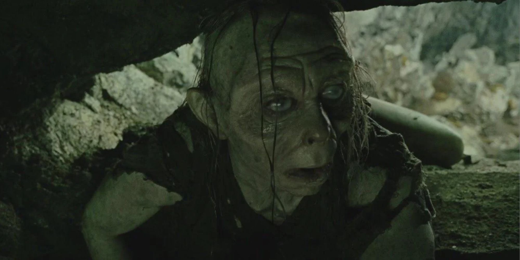 Gollum crawls into the cave, waiting for his transformation to finish.