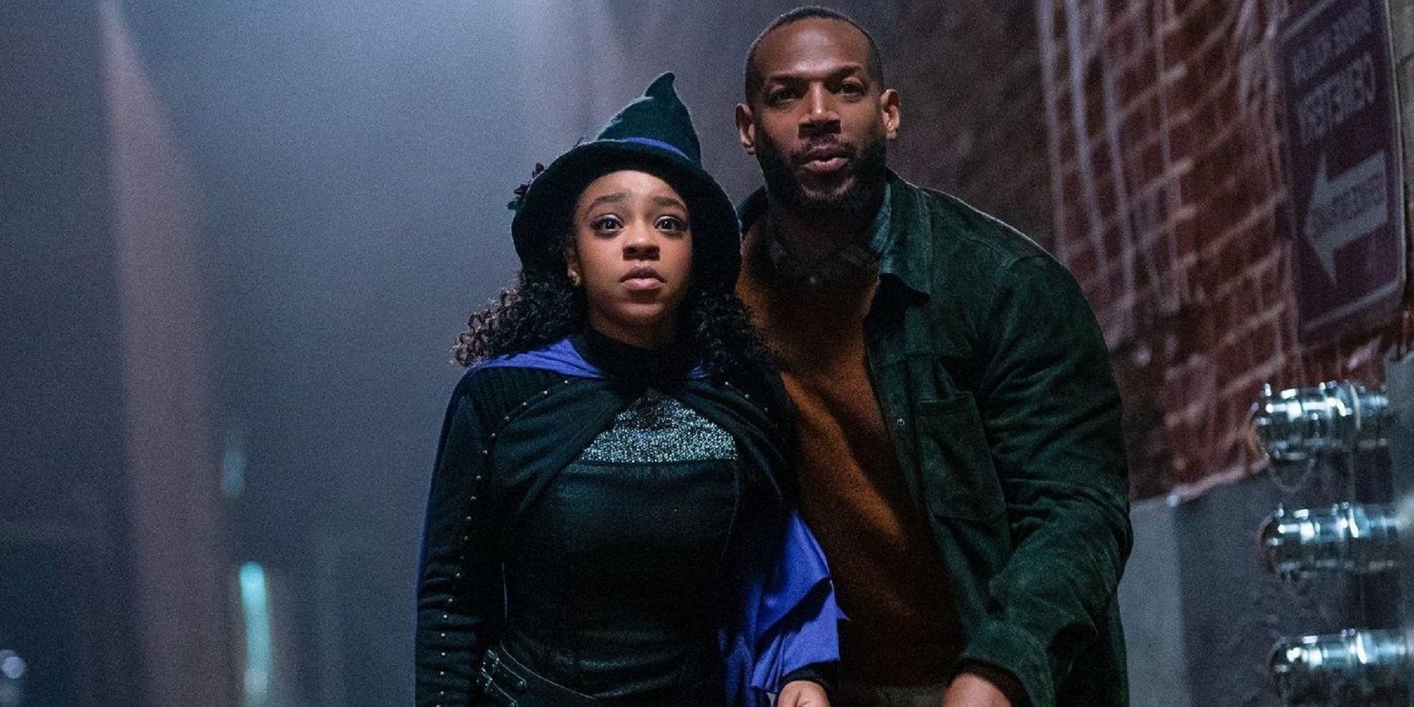 Marlon Wayans' character and his daughter appear frightened in an alleyway in The Curse of Bridge Hollow.