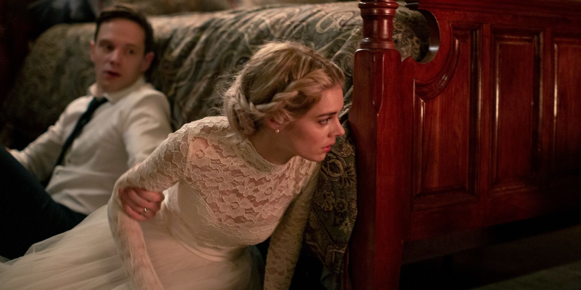 The bride and groom hide behind the bed ready or not