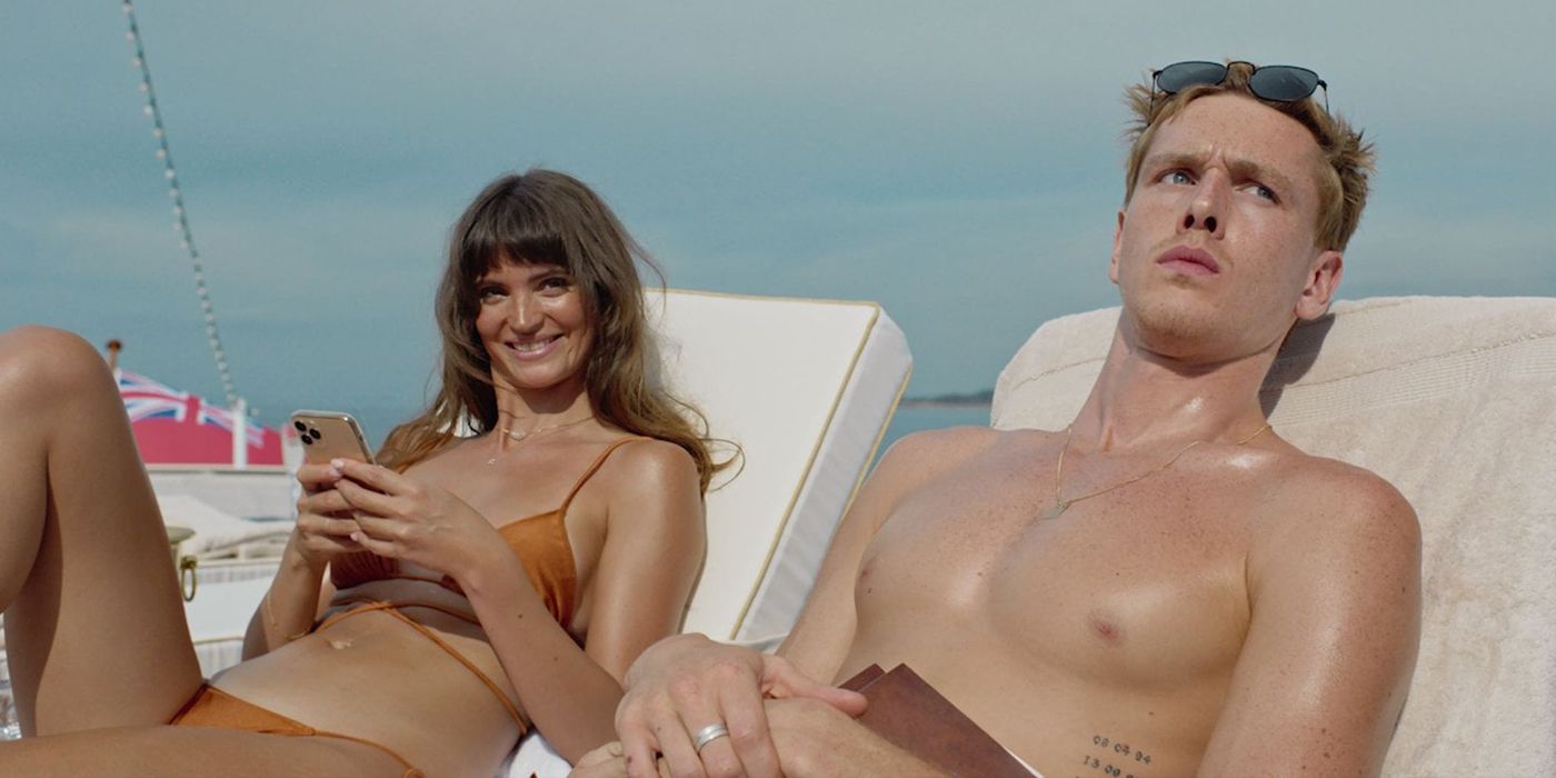A young man and woman are sunbathing and looking in the same direction in the Triangle of Sorrow.