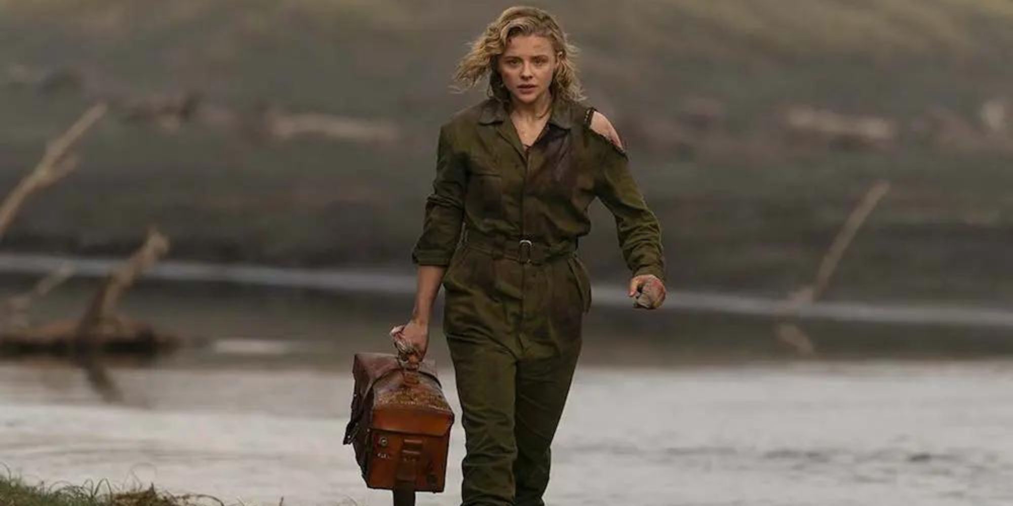 Shadow in the Cloud pilot Maude Garrett carries top secret documents on the beach.
