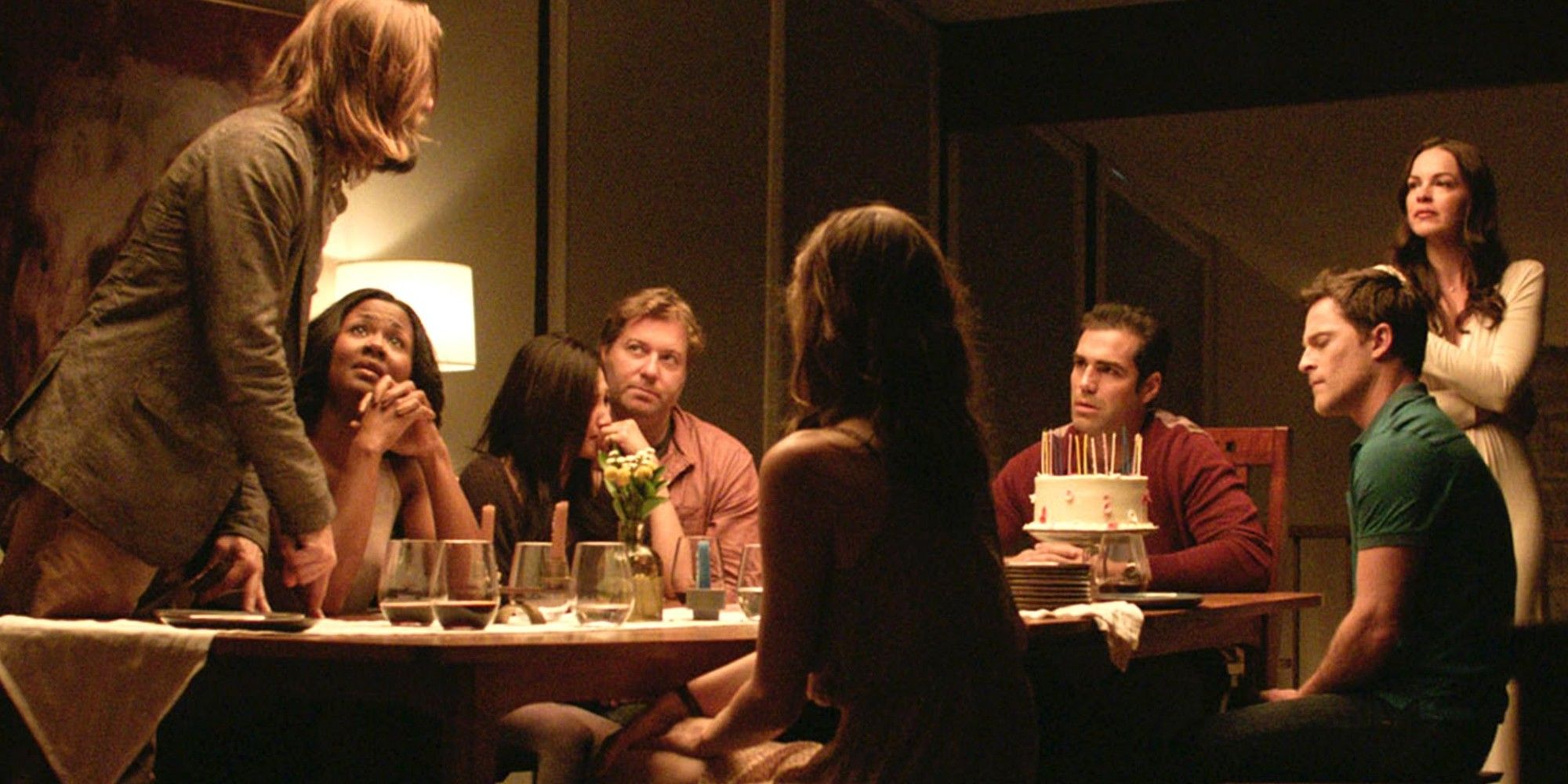 The cast of The Invitation, including Logan Marshall Green, gather around the dinner table.