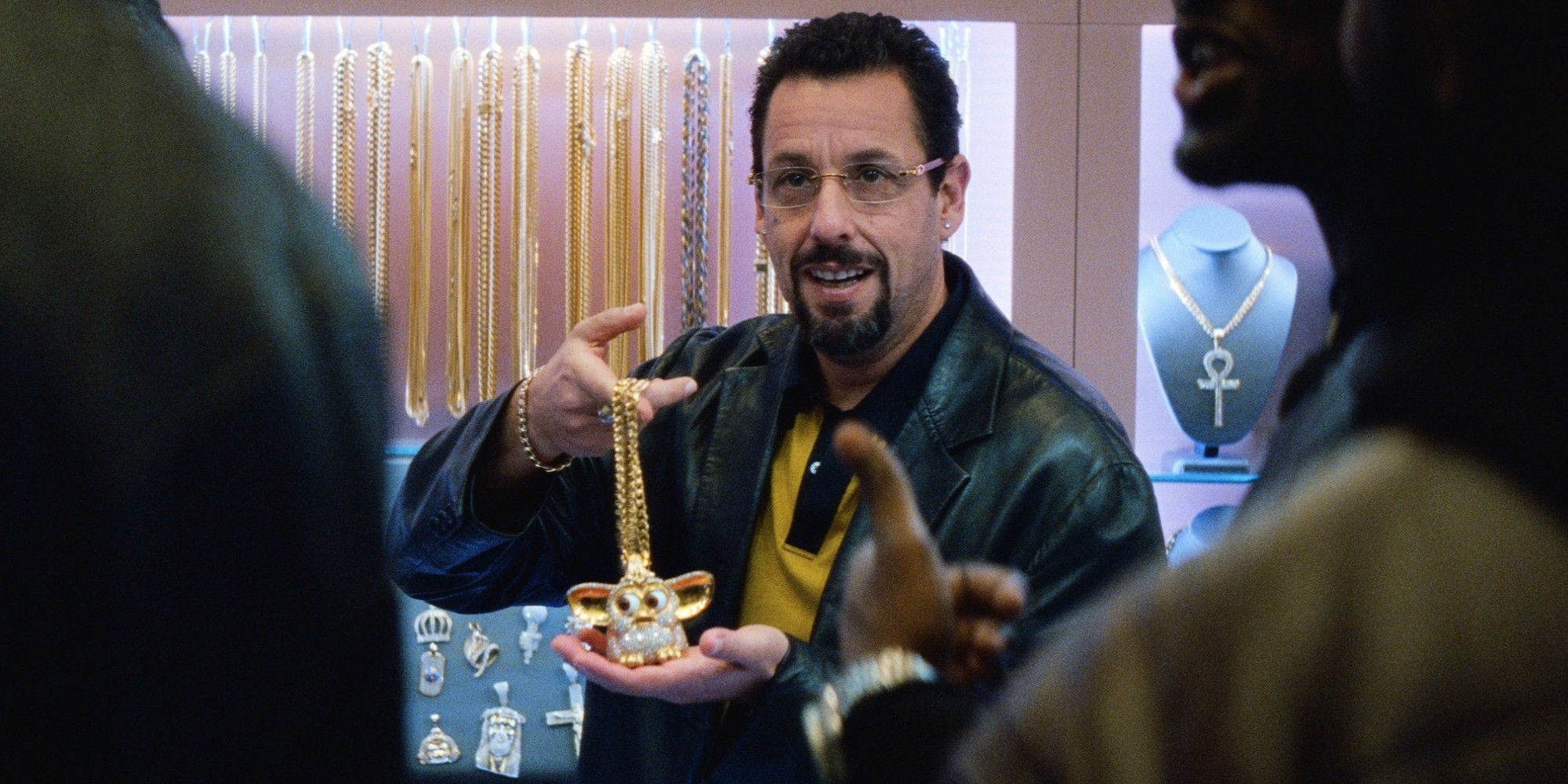 Adam Sandler wearing a gold necklace in Uncut Gems