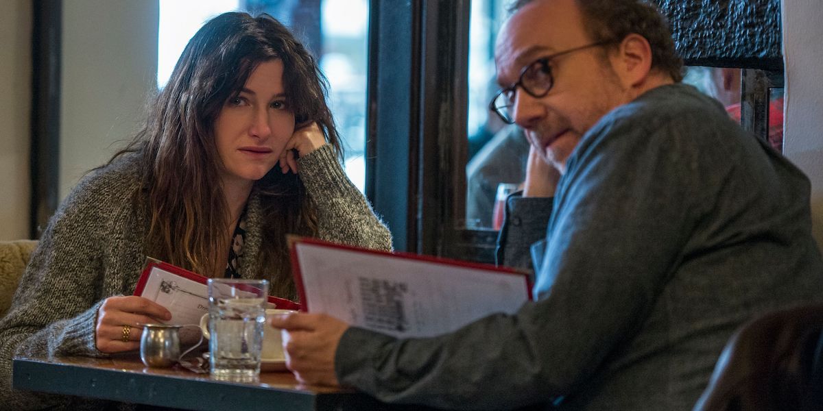 Kathryn Hahn as Rachel and Paul Giamatti as Richard at a table in Netflix's Private Life.