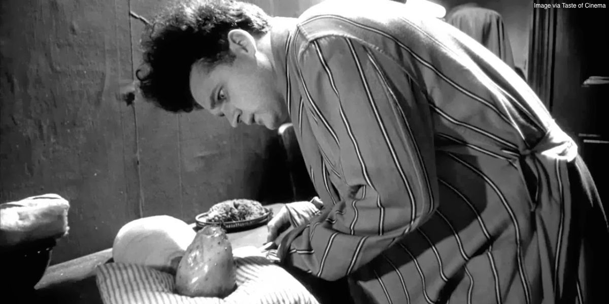 Jack Nance as Henry Spencer looks at a deformed baby in Eraserhead.