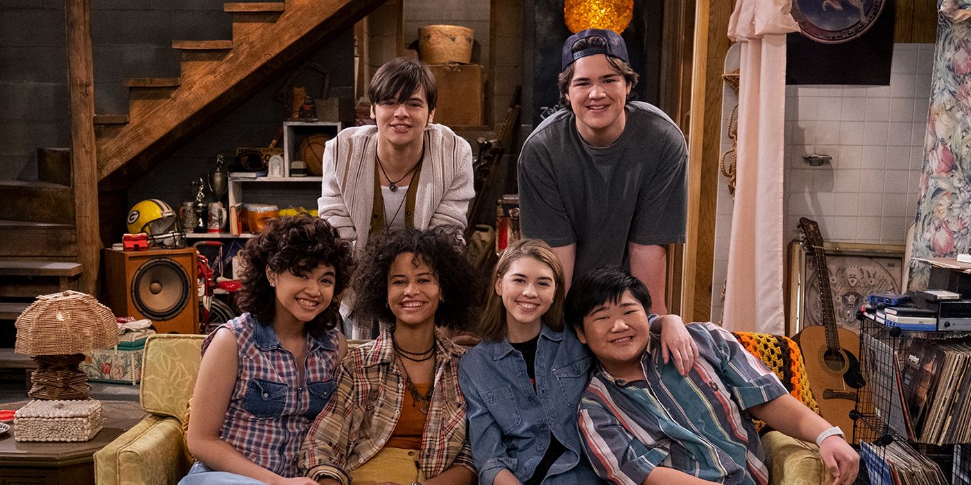 The cast of That '90s Show sit on a couch in Foreman's iconic That '70s Show basement.