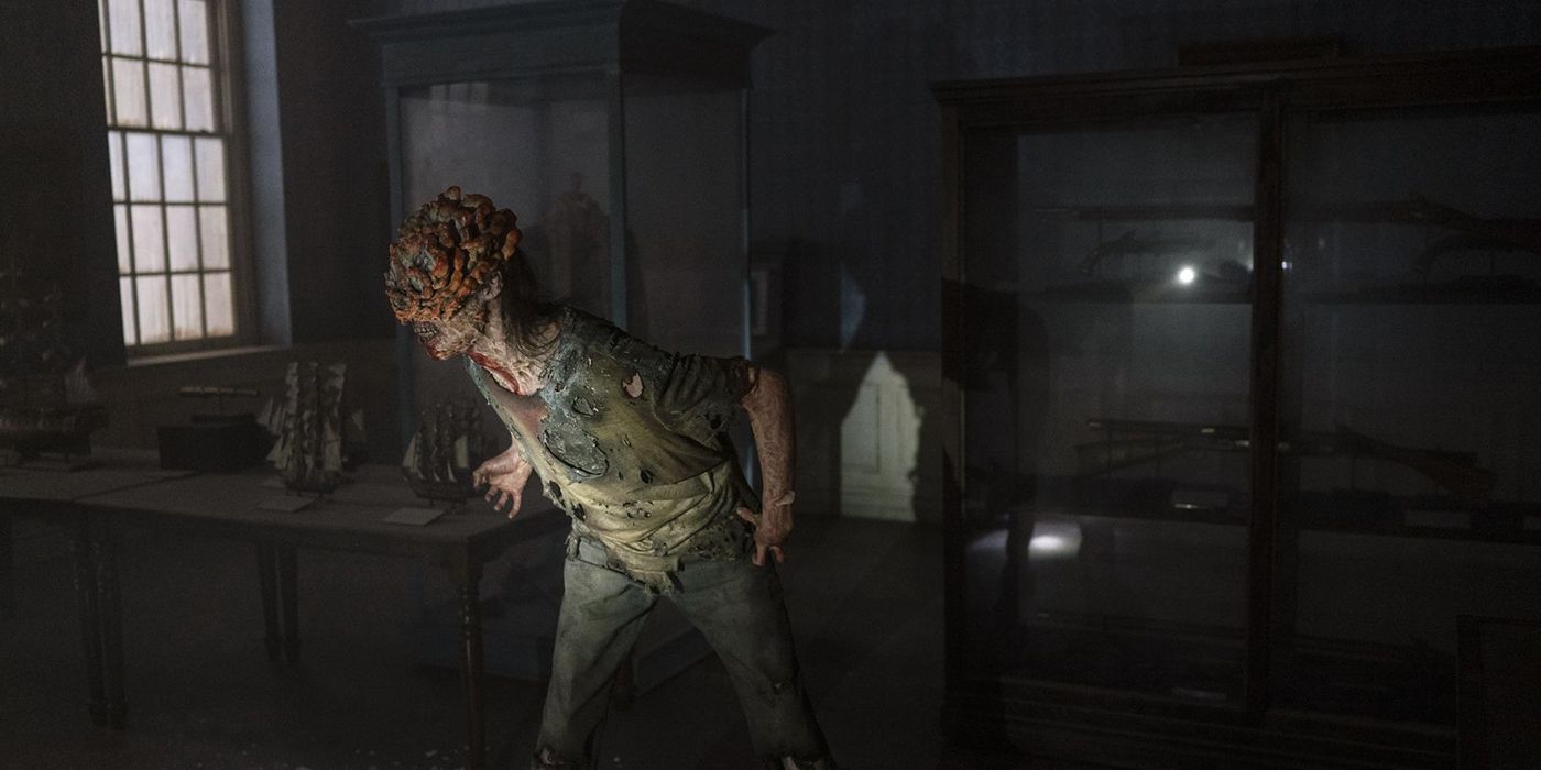 A former human infected with Cordyceps squeals in a dark room in The Last of Us.