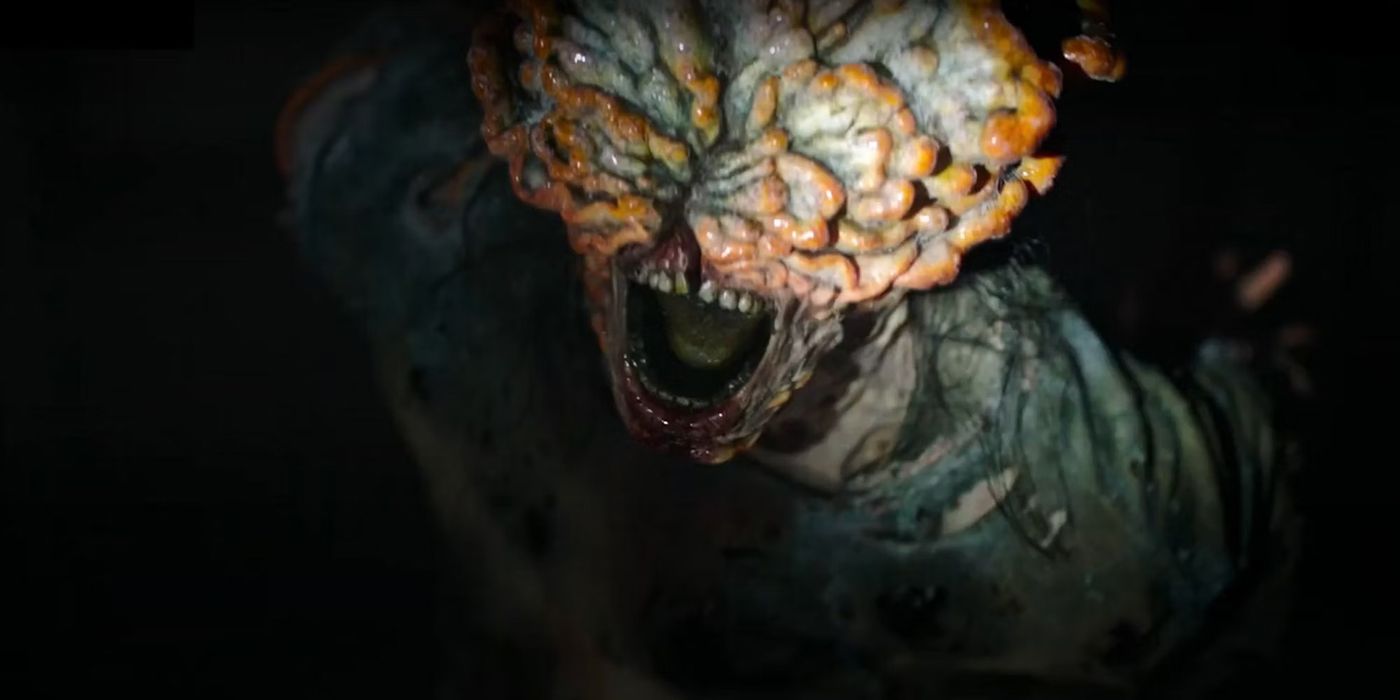 A close-up of an infected monster in The Last of Us with its mouth open and its head covered in fungus.