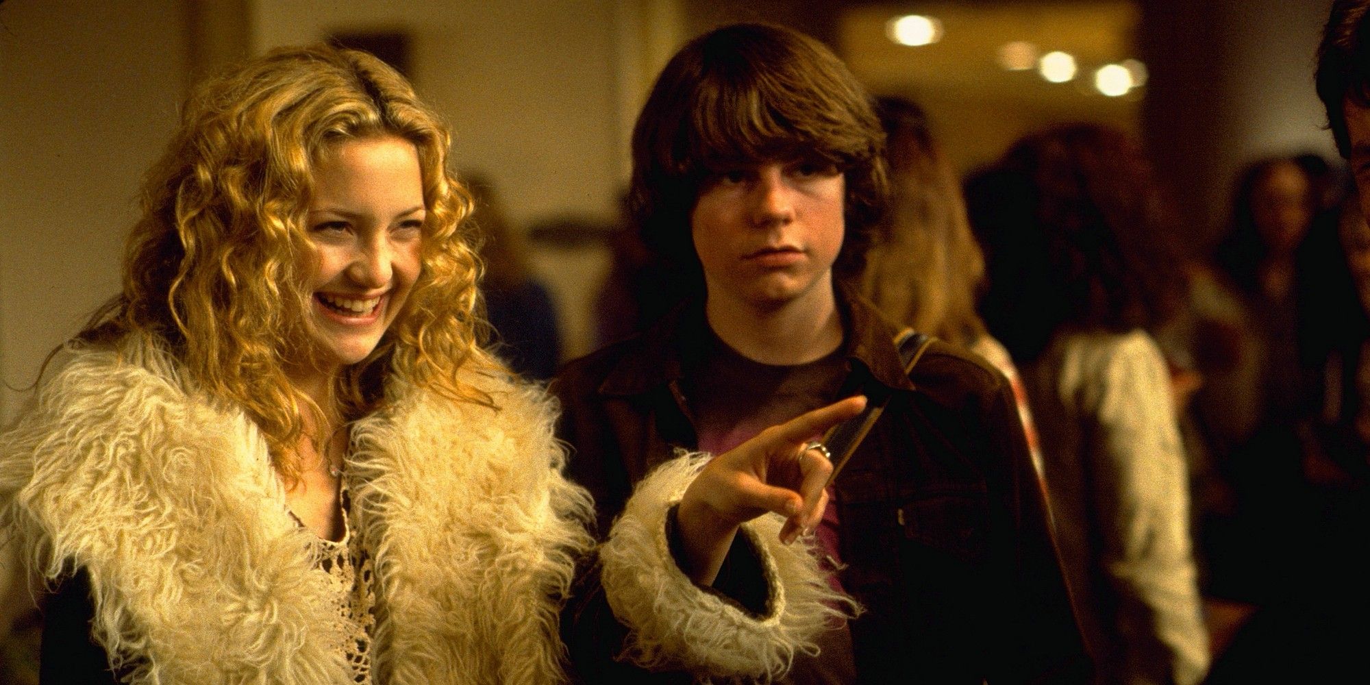 Kate Hudson points and smiles next to Patrick Fugit in Almost Famous.