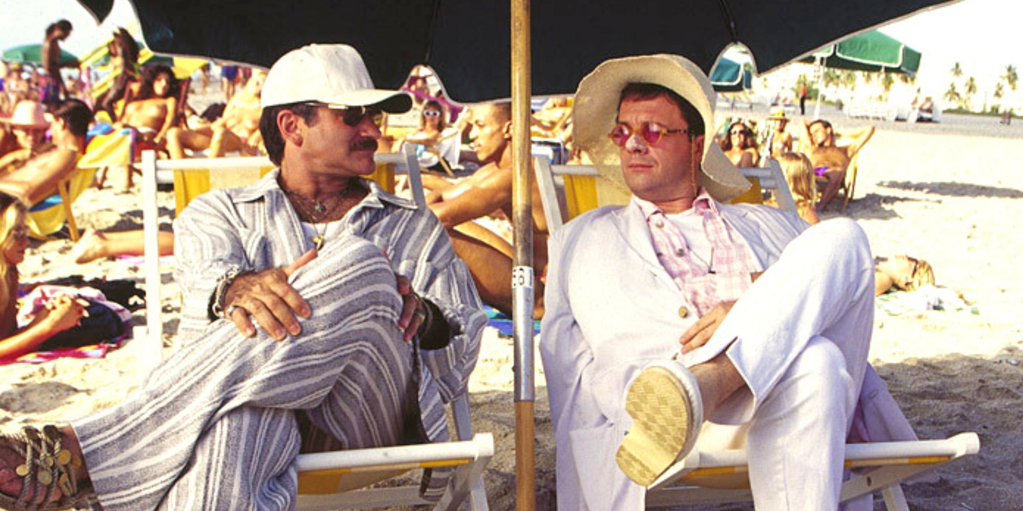 Robin Williams sits next to Nathan Lane on the beach in The Birdcage.