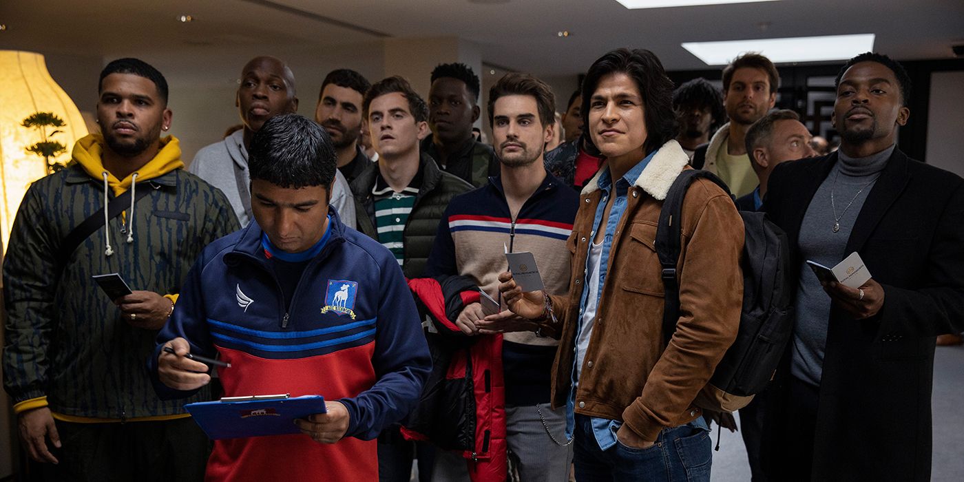 The players of AFC Richmond stand together, in front of them is Nate with a tablet on Ted Lasso.