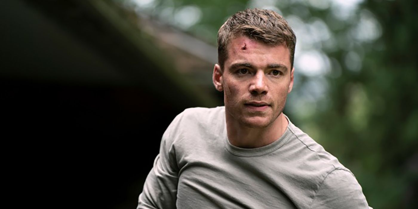 Peter looks at someone, a cut on his forehead in a scene from The Night Agent.