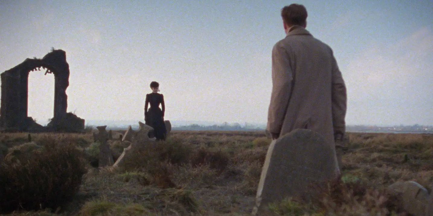 The lawyer is confronted by a ghostly figure in black in a graveyard.