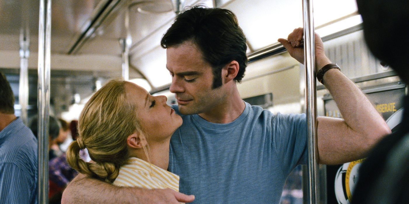 Amy Schumer and Bill Hader as Amy and Aaron kissing on the train in Trainwreck