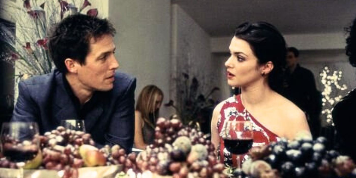 Hugh Grant and Rachel Weisz sit at the dinner table talking in About a Boy.