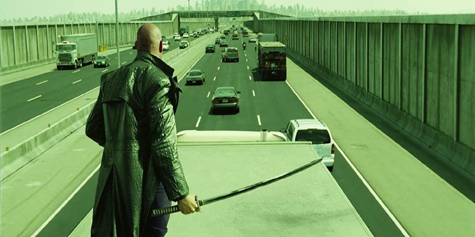 Laurence Fishburne as Morpheus standing on the floor in The Matrix Reloaded. 
