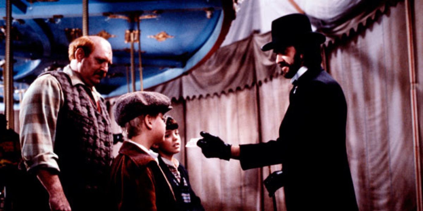 Jonathan Pryce, as Mr. Dark, hands two boys and a man a small piece of paper in Something Evil Is Coming.