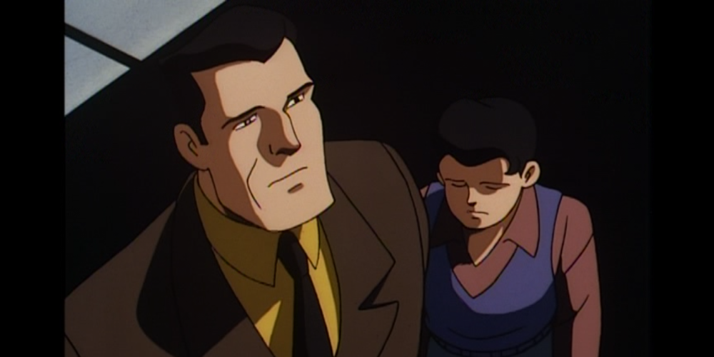 Bruce Wayne standing with sad Dick Grayson